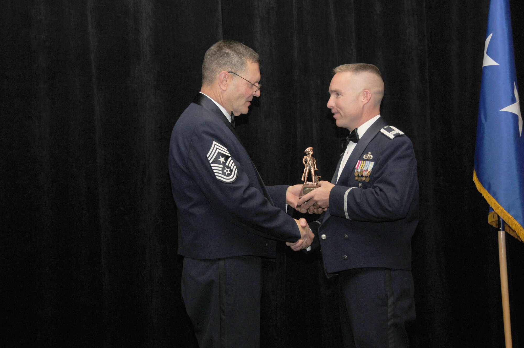 Capt. Jason Burns from the 162nd Fighter Wing, Tucson Ariz, is the Arizona Air National Guard’s Maj. Gen. Donald L. Owens Award winner. Captain Burns accepts his award from Arizona State Command Chief Daniel Irving on Saturday March 5, 2011.  (U.S. Air Force photo by Airman 1st Class Rashaunda Williams/Released)