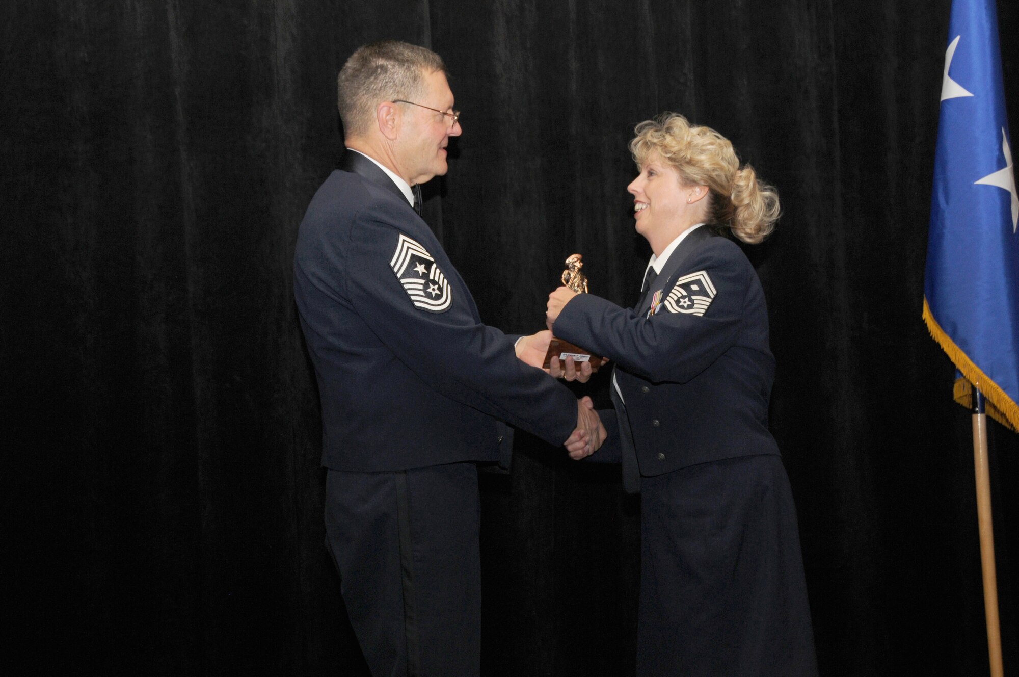 Senior Master Sgt. Judy Dillman from the 161st Air Refueling Wing, Phoenix Ariz, is the Arizona Air National Guard’s First Sergeant of the Year. Sergeant Dillman accepts her award from Arizona State Command Chief Daniel Irving on Saturday March 5, 2011.  (U.S. Air Force photo by Airman 1st Class Rashaunda Williams/Released)