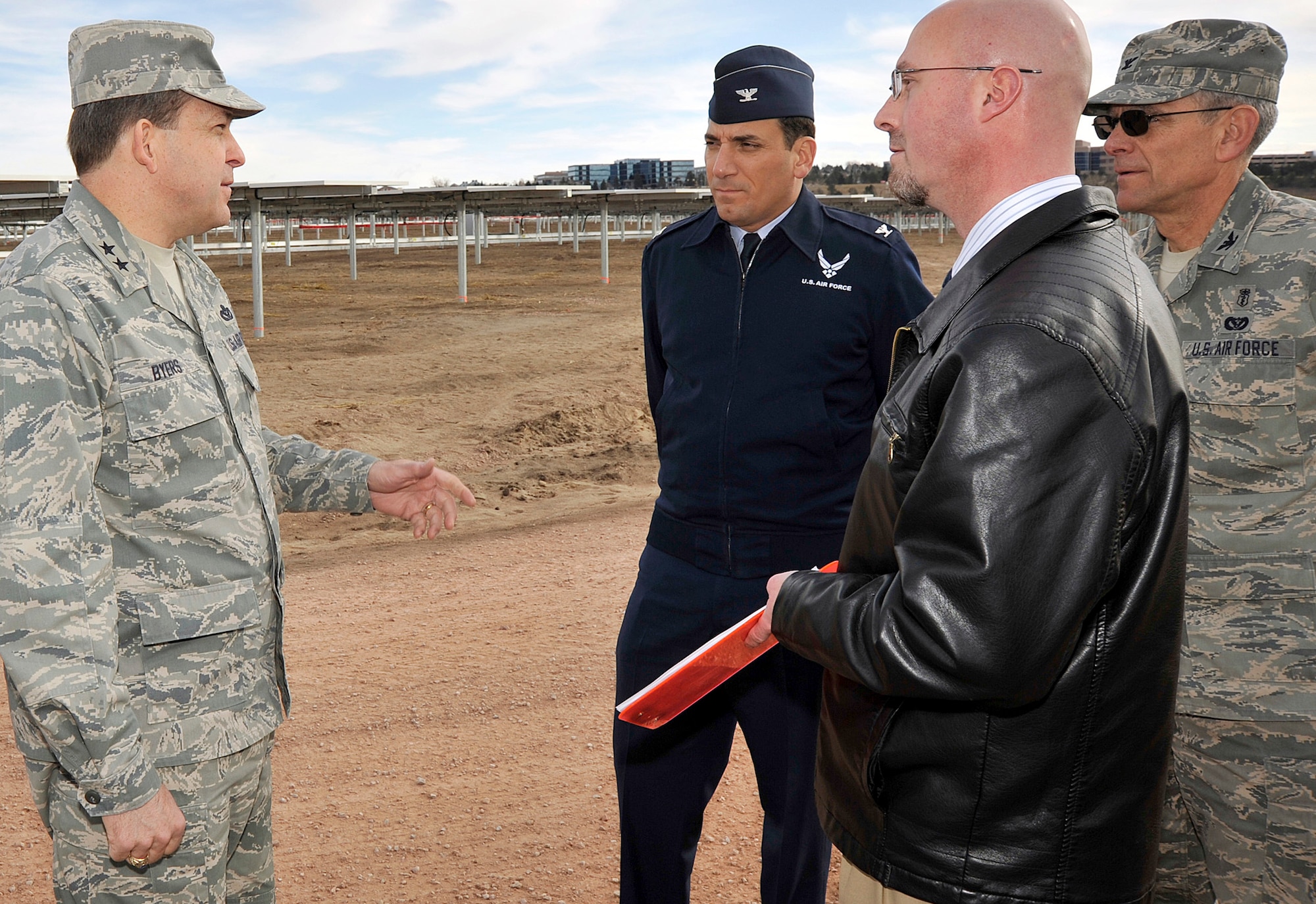 Maj. Gen. Timothy Byers speaks with Col. Rick LoCastro, Russ Hume and Col. Gregory Seely during a visit to the U.S. Air Force Academy's solar array March 4, 2011, at Colorado Springs, Colo. The array is scheduled to generate its first megawatt of power in March and ramp up to its full 6MW capacity by the end of April. General Byers is the Air Force Civil Engineer and graduate of the University of Kentucky. Colonel LoCastro is the Academy's 10th Air Base Wing commander. Colonel Seely is the director of Installation and Mission Support, and Mr. Hume is an engineer with the A7 directorate. (U.S. Air Force photo/Bill Evans) 