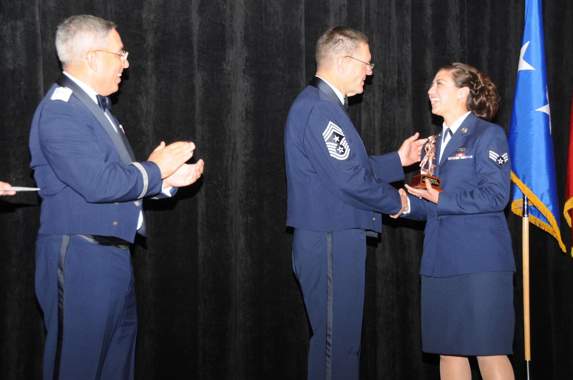 Senior Airman Amanda Gast from the 214th Reconnaissance Group, Tucson Ariz, is the Arizona Air National Guard’s Airman of the Year.  Airman Gast accepts her award from Arizona State Command Chief Daniel Irving and Brig. Gen. Michael Colangelo, Commander, Arizona Air National Guard on Saturday March 5, 2011.  (U.S. Air Force photo by Airman 1st Class Rashaunda Williams/Released)