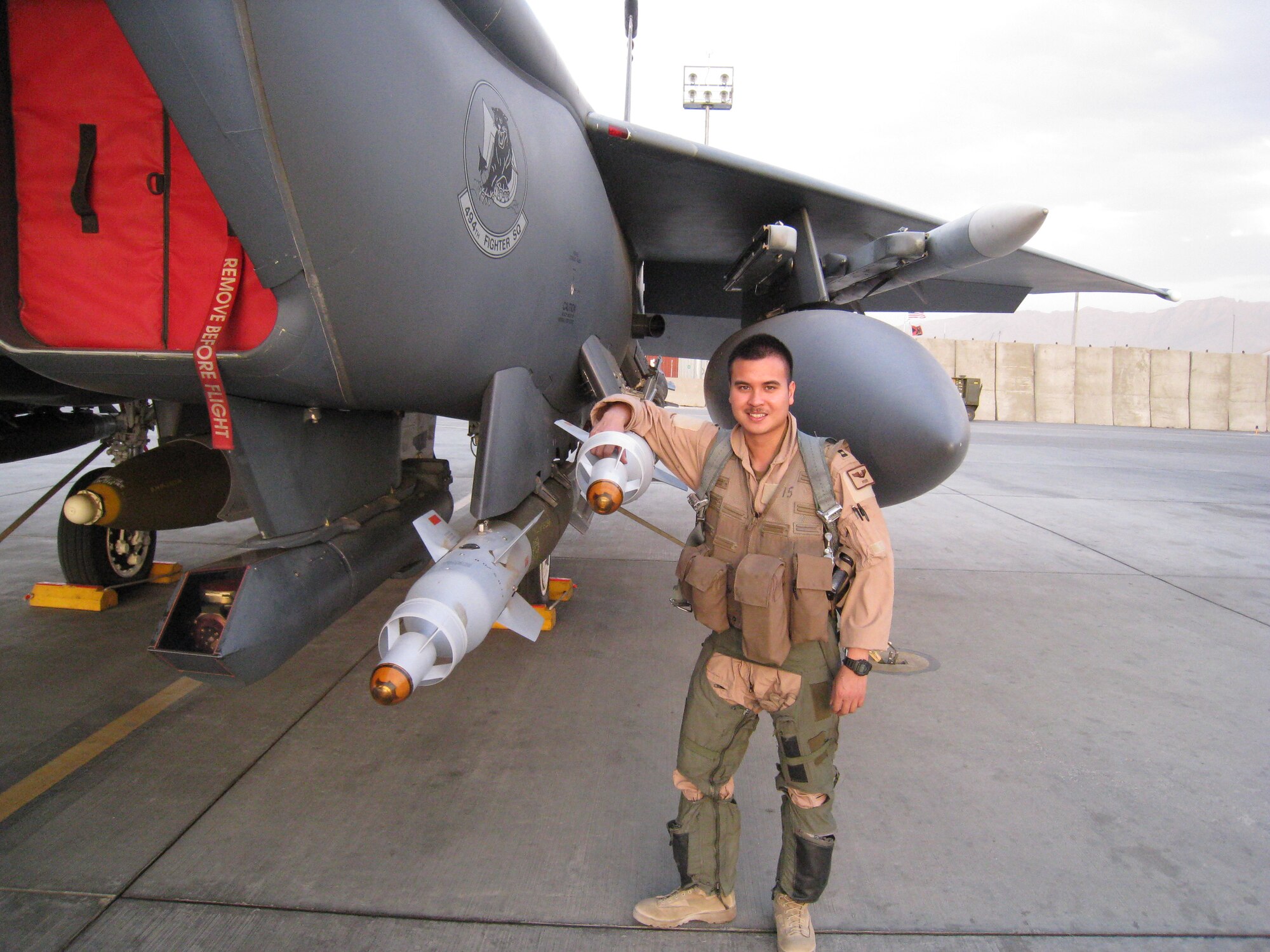 BAGRAM AIRFIELD, Afghanistan – Capt. Alain “Pedro” Martinez stands next to his F-15E Strike Eagle with his hand on a GBU-12 before flying a combat mission over Afghanistan. While assigned to the 494th Expeditionary Fighter Squadron, Captain Martinez completed a five month deployment to Afghanistan in support of Operation Enduring Freedom. Captain Martinez hails from San Diego. (Courtesy Photo)