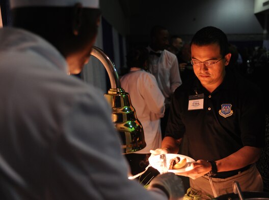 1st Lt. Raul Chang, 9th Air Force communication officer in charge, gets dinner during the icebreaker gathering for the Outstanding Performers of the Year held at the James H. Rainwater Conference Center in Valdosta, Ga., March 9. Food and drinks were provided to nominees and their wing representatives after the medallion ceremony. (U.S. Air Force photo Airman 1st Class Benjamin Wiseman)(RELEASED)