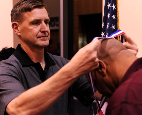 Maj. Gen. Stephen Hoog, 9th Air Force commander Shaw Air Force Base, S.C., places a medallion on a nominee for the Outstanding Performers of the Year at the James H. Rainwater Conference Center in Valdosta, Ga., March 9. Each nominee was presented with a medallion during the ceremony. (U.S. Air Force photo/Airman 1st Class Benjamin Wiseman)(RELEASED)