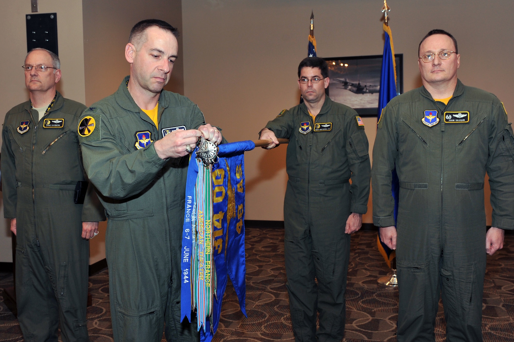 Col. Mark Czelusta, 314th Airlift Wing commander, places the Berlin Airlift streamer on the 48th Airlift Squadron guidon, Feb. 4, 2011, at Little Rock Air Force Base, Ark.  The 48th Airlift Squadron was activated on May 30, 1942, and was later re-designated as the 48th Troop Carrier Squadron and participated in the Berlin Airlift flying the C-54. Past squadron members attended the ceremony, including Col. David Kasberg (left), 19th Operations Group commander, who was a previous commander of the 48th AS.   (U.S. Air Force photo by Staff Sgt. Chris Willis)