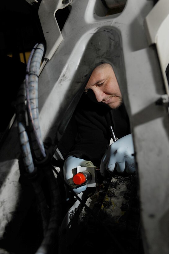 Brandon Simmons, Safety Time Compliance Technical Order team member, assembles a brake modification on a B-1B Lancer at Ellsworth Air Force Base, S.D., March 2, 2011. The Safety TCTO team is removing the original design hard-brake swivels and replacing them with a flexible hose, which will generate less wear and tear on the braking system of the B-1. (U.S. Air Force photo/Senior Airman Kasey Close)