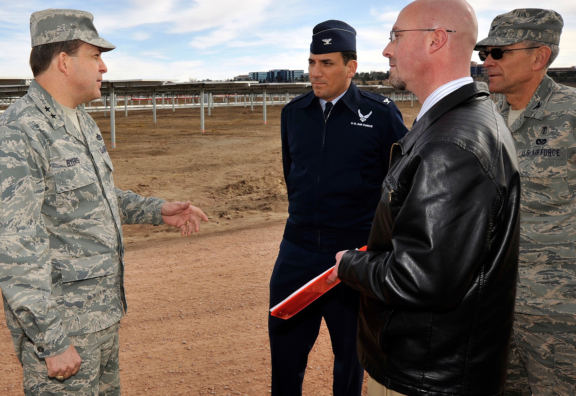 Maj. Gen. Timothy Byers speaks with Col. Rick LoCastro, Russ Hume and Col. Gregory Seely during a visit to the Air Force Academy's solar array March 4, 2011. The array is scheduled to generate its first megawatt of power in March and ramp up to its full 6MW capacity by the end of April. General Byers is the Air Force Civil Engineer and graduate of the University of Kentucky. Colonel LoCastro is the Academy's 10th Air Base Wing commander. Colonel Seely is the director of Installation and Mission Support, and Mr. Hume is an engineer with the A7 directorate. (U.S. Air Force photo/Bill Evans)