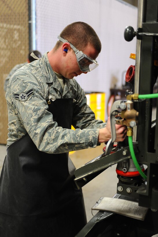 Airman 1st Class Trevor Newsome, 28th Logistics Readiness Squadron fuels technician, connects a fuel hose to a fuel truck after inspecting it for leaks at Ellsworth Air Force Base, S.D., March 7, 2011. The inspection was part of daily vehicle inspection to ensure a mission ready vehicle. (U.S. Air Force photo/Senior Airman Kasey Close)