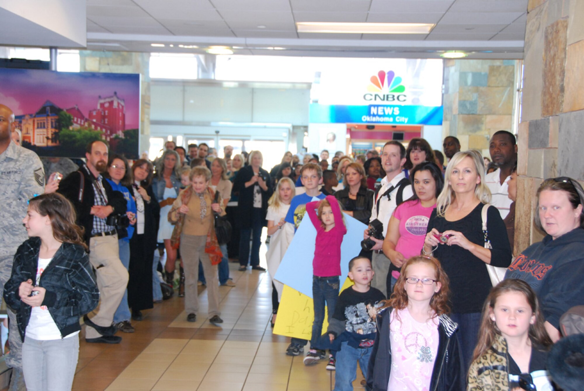 Dozens of family members and well-wishers gathered yesterday to greet the return of 28 Air Force reservists from the 507th Civil Engineer Squadron.  The reservists, all members of the 507th Air Refueling Wing at Tinker AFB, had been deployed for six months to the mid east.