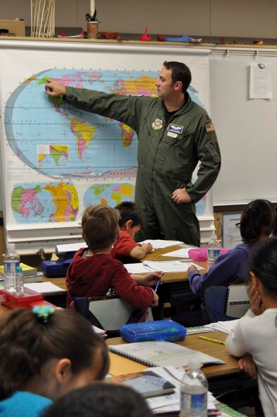 Air Force Capt. Jamie Studer uses a map to respond to questions from Mrs. Baker's third grade class at John F. Kennedy Elementary School in Riverside, Calif., during Read Across America Day, March 2, 2011.  Captain Studer, is a KC-135 Stratotanker pilot with the 912th Air Refueling Squadron at March Air Reserve Base, Calif.  (U.S. Air Force photo by Megan Just)