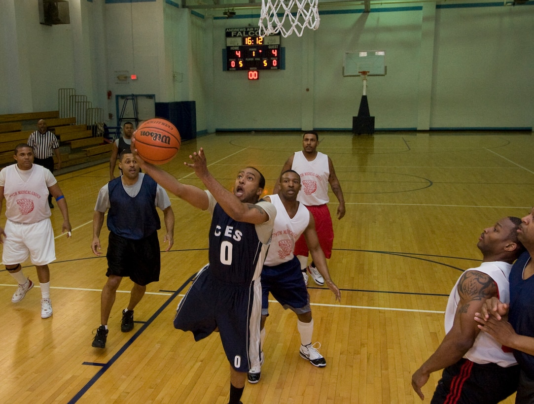 Derrick “Doc” Jones, 11th Civil Engineer Squadron guard, drives down the lane with a lay up against the 779th Medical Group defense during the first intramural basketball playoff series at the East Fitness Center March 7. The 11 CES who boasts a 10 – 1 record is the intramural basketball regular season champions. The 11 CES beat the 779 MDG 48 to 41. (U.S. Air Force photo/Bobby Jones)