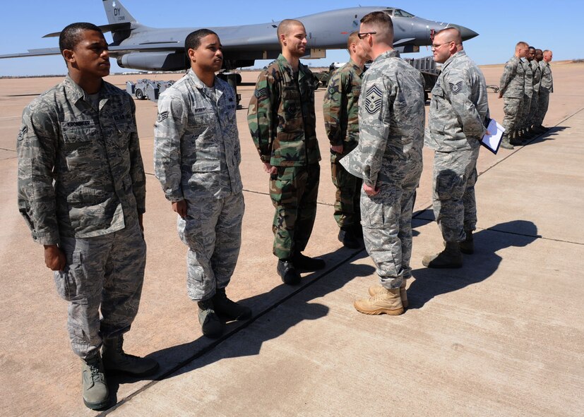 DYESS AIR FORCE BASE, Texas – Chief Master Sgt. Douglas McIntyre, 7th Bomb Wing Command Chief, performs an open ranks inspection on the weapons load crew before a load crew competition here, March 9. The load crew competition is a timed weapons load based on safety and efficiency. The 7th Bomb Wing walked away with five of 14 trophies in last year’s first-ever Global Strike Challenge. The seven-month long competition is set to begin again in April. (U.S. Air Force photo/ Airman 1st Class Chelsea Cummings)