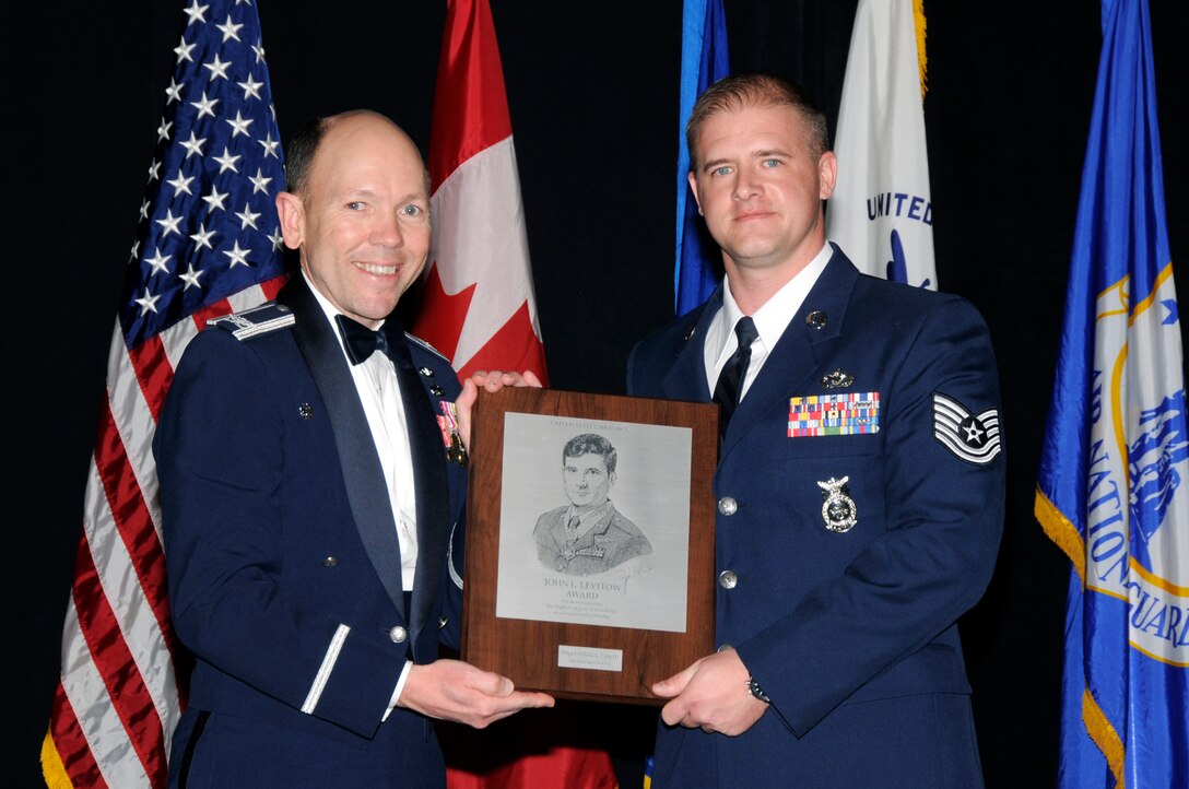 McGHEE TYSON AIR NATIONAL GUARD BASE, Tenn. - Tech. Sgt. Clifford Otto III, right, receives the John L. Levitow honor award for NCO Academy Class 11-2 at The I.G. Brown Air National Guard Training and Education Center here from Col. Bradley N. McRee, TEC commander, Feb. 10, 2011.  The John L. Levitow award is the highest honor awarded a graduate of any Air Force enlisted professional military education course.  (U.S. Air Force photo by Master Sgt. Kurt Skoglund/Released)