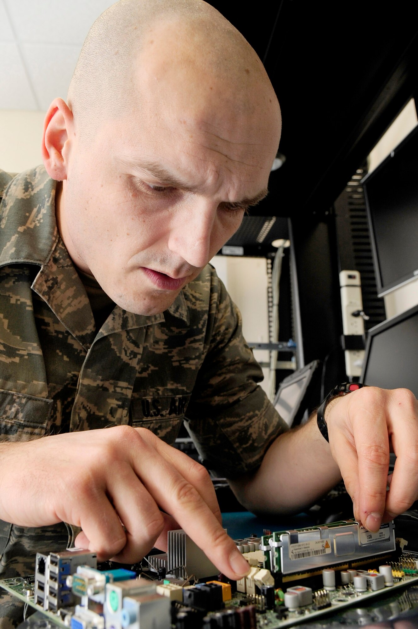 RAF MILDENHALL, England -- Senior Airman Sanel Velic, 133rd Airlift Wing communications technician, adds memory to a new motherboard here March 9, 2011. Airman Velic is from the Minnesota Air National Guard and is here on a two-week deployment for training. (U.S. Air Force photo/Senior Airman Ethan Morgan)