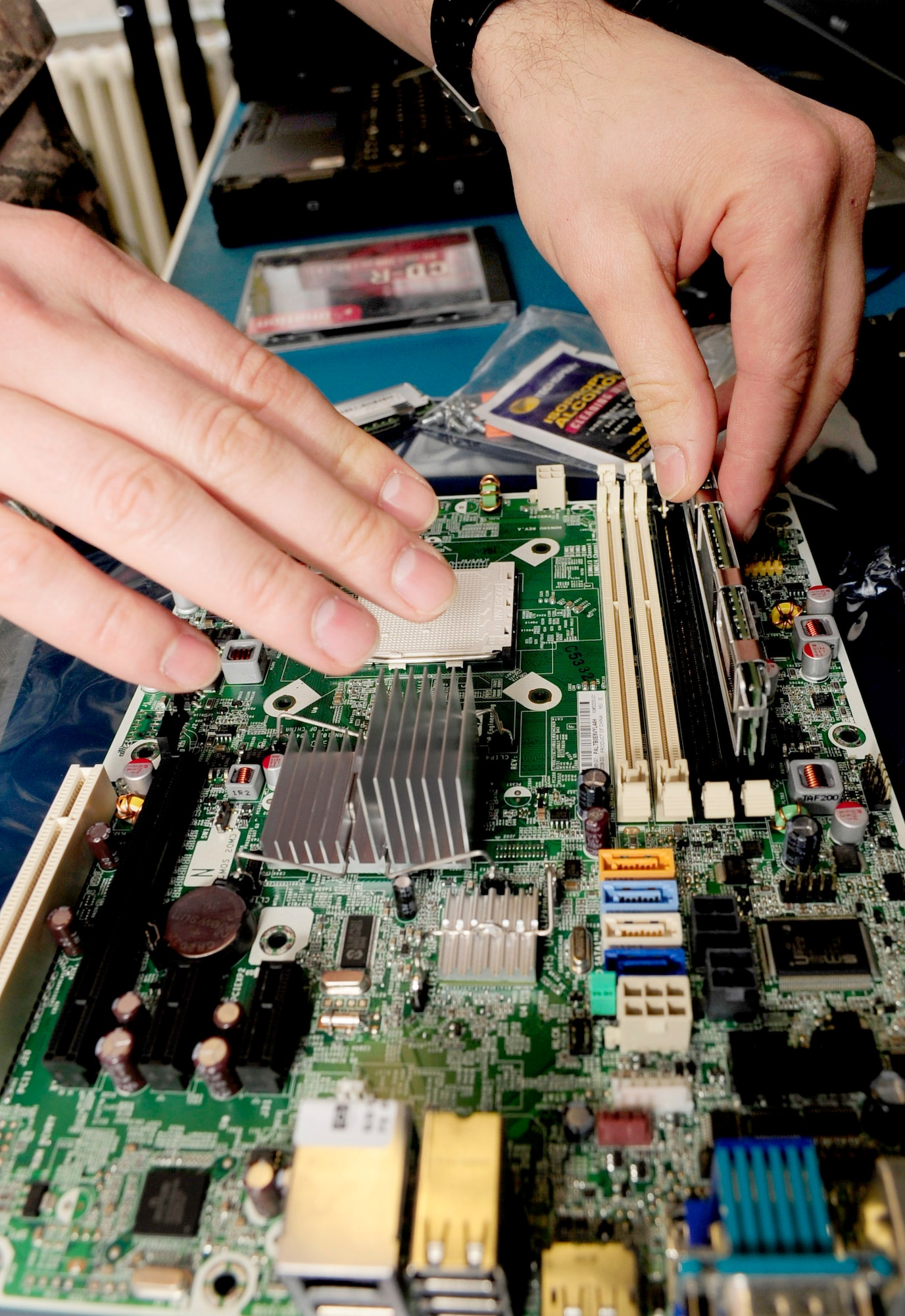 RAF MILDENHALL, England -- Senior Airman Sanel Velic, 133rd Airlift Wing communications technician, adds memory to a new motherboard here March 9, 2011. The new motherboard will replace an existing one either as an upgrade or a replacement. (U.S. Air Force photo/Senior Airman Ethan Morgan)