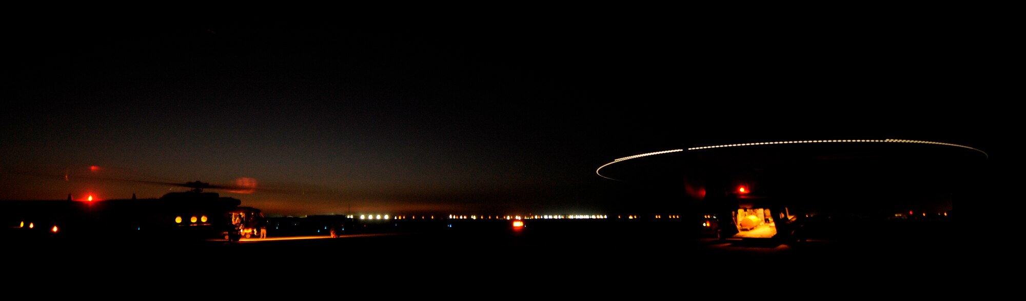 CAMP TAJI, Iraq -- A pair of Iraqi Mi-171 multi-mission helicopters prepare for takeoff as the sun sets in the distance. Iraq Training and Advisory Mission - Air advisor pilots from the U.S. Air Force are teaching Iraqi pilots how to fly missions using night vision goggles to ensure the country has 24/7 intelligence, surveilance and reconnaissance overwatch capabilities. (U.S. Air Force by Tech. Sgt. Jason Lake)