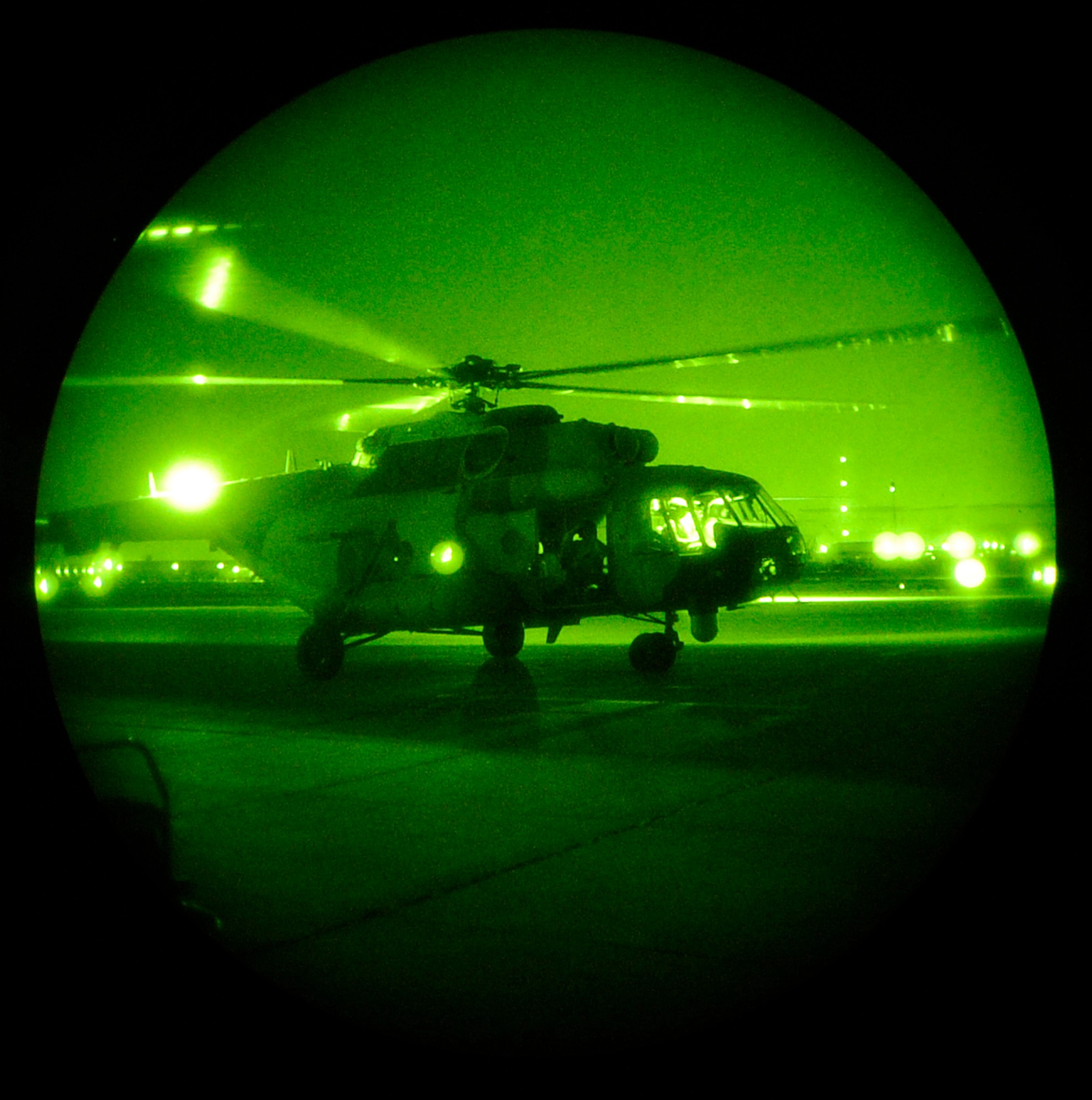 CAMP TAJI, Iraq -- U.S. Air Force Maj. Eric Vanley and his Iraqi Mi-171MM helicopter co-pilot go through their pre-flight checklist before taking off on an Iraq Training and Advisory Mission-Air night-vision goggle training mission, March 1. (U.S. Air Force/Tech. Sgt. Jason Lake)