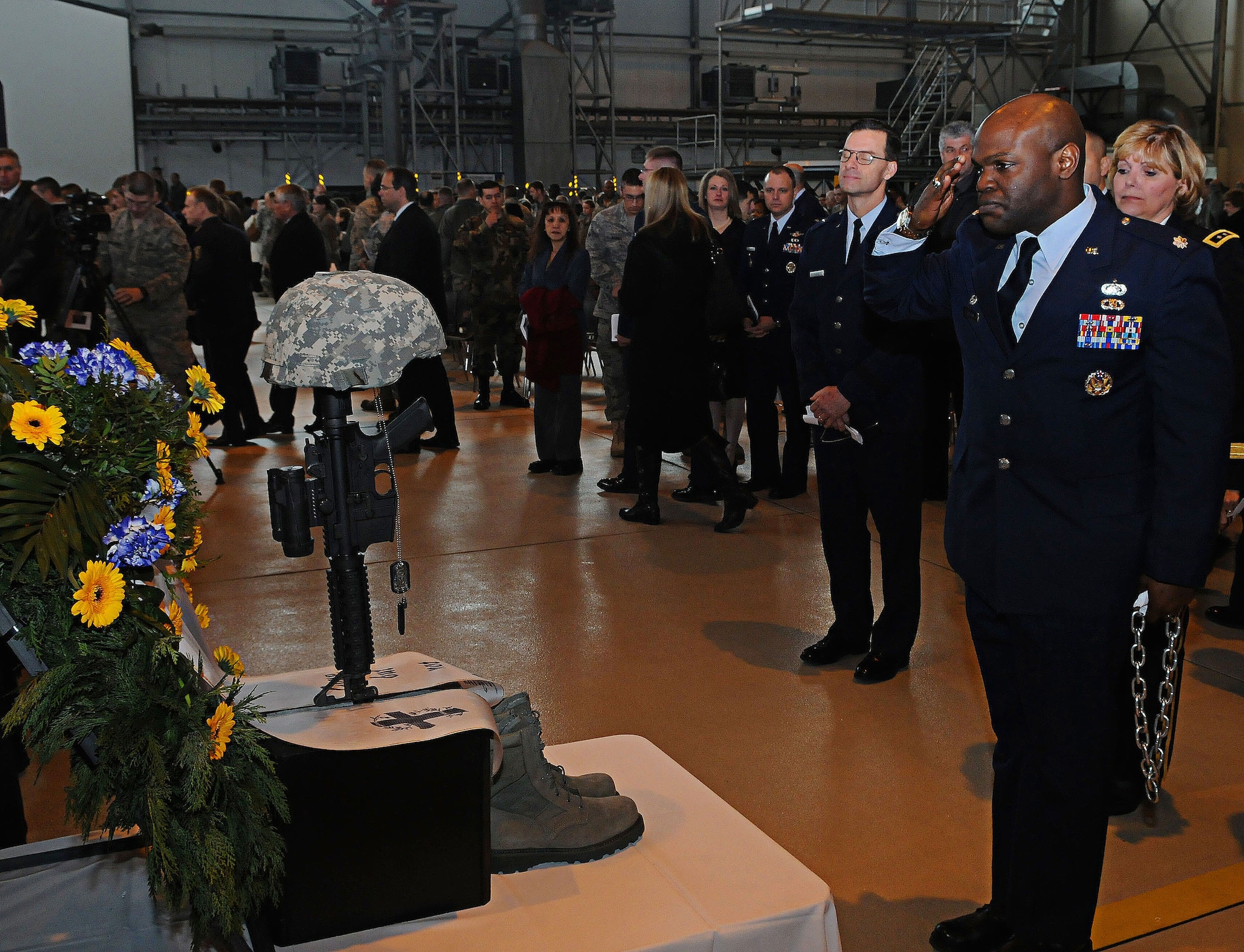 U.S. Air Force Lt. Col. Uduak Udoaka, 86th Vehicle Readiness Squadron commander, pays his respects during the memorial service for Airman 1st Class Zachary Cuddeback, 86th Vehicle Readiness Squadron, Ramstein Air Base, Germany, March 10, 2011. Airman Cuddeback was killed in action at Frankfurt International Airport March 2, 2011.   (U.S. Air Force photo by Airman 1st Class Desiree Whitney Esposito)