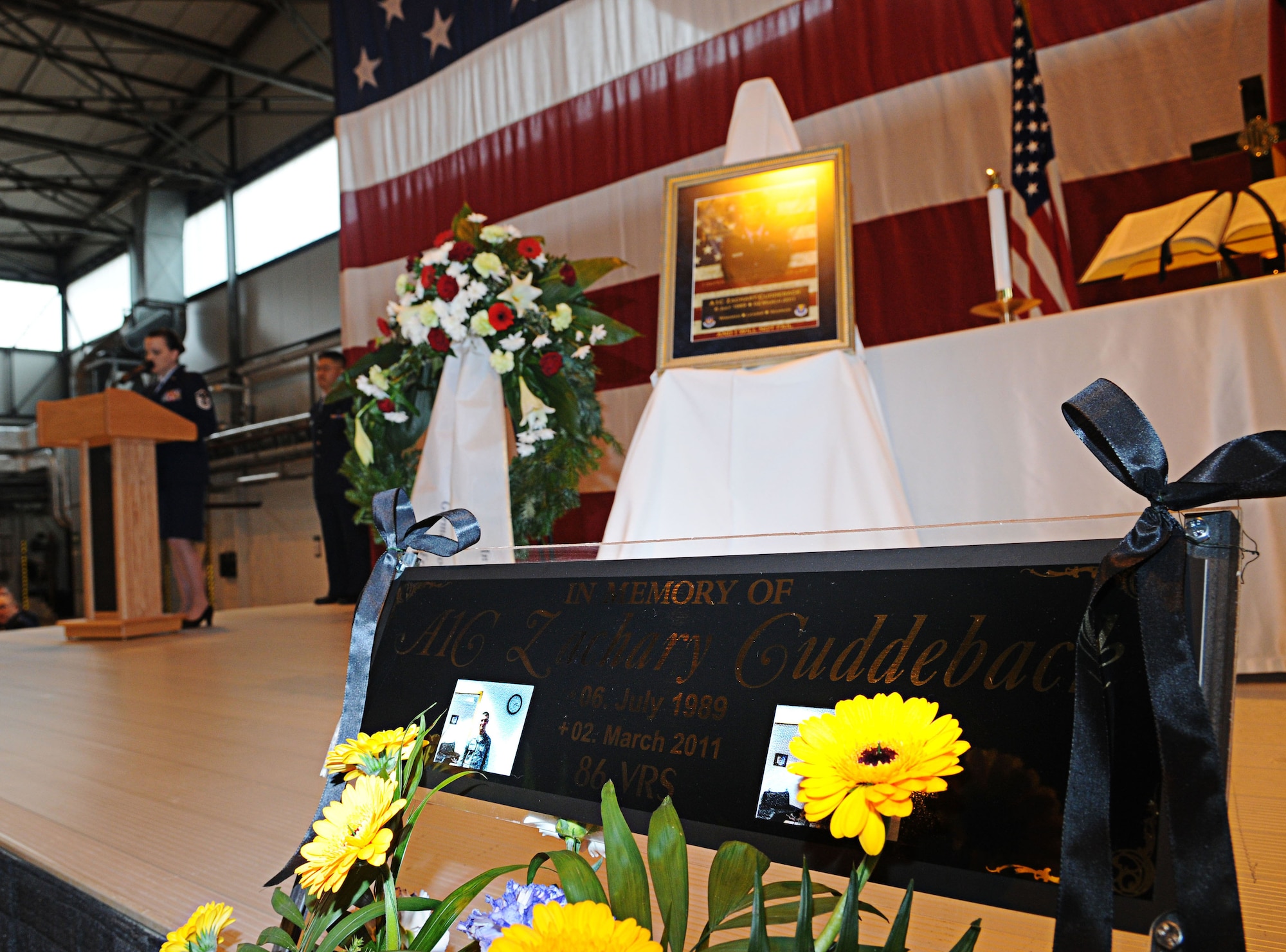 U.S. Air Force Master Sgt. April Owen, 86th Vehicle Readiness Squadron, reads a letter that Mr. Cuddeback wrote for his son during the memorial service, Ramstein Air Base, Germany, March 10, 2011. Airman 1st Class Zachary Cuddeback, 86th Vehicle Readiness Squadron was killed in action at Frankfurt International Airport March 2, 2011. (U.S. Air Force photo by Airman 1st Class Desiree Whitney Esposito)