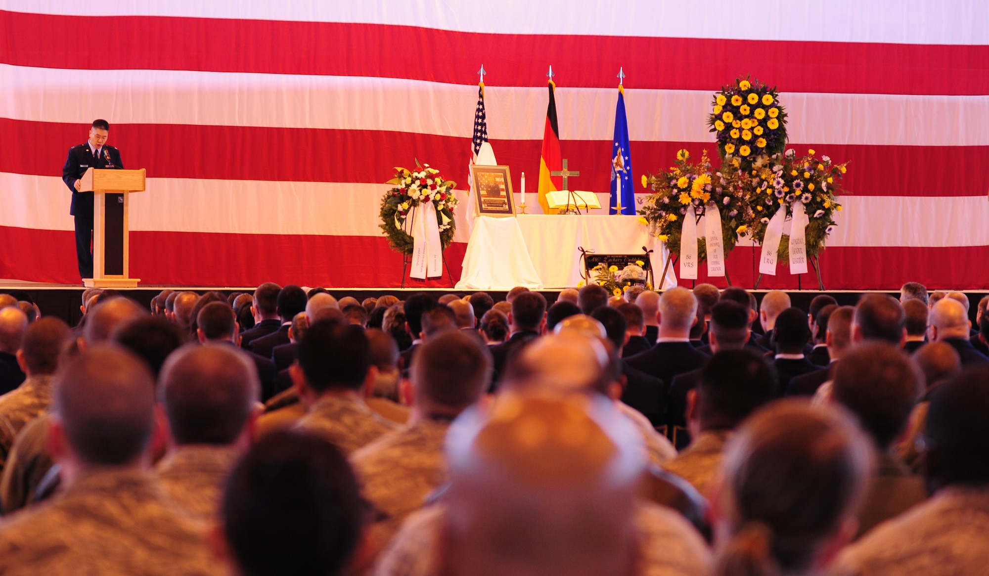 U.S. Air Force Capt. David Suh, 86th Airlift Wing chaplain, presides over a memorial ceremony for Airman 1st Class Zachary Cuddeback, 86th Vehicle Readiness Squadron, Ramstein Air Base, Germany, March 10, 2011. Airman Cuddeback was killed in action at Frankfurt International Airport March 2, 2011. (U.S. Air Force photo by Senior Airman Brittany Perry)