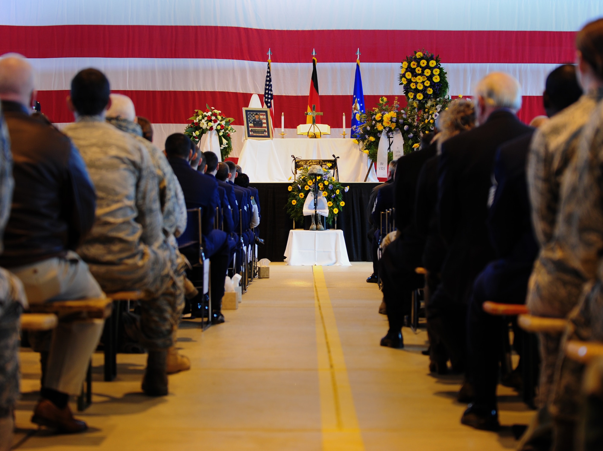 Airmen pay their respects during a memorial ceremony for Airman 1st Class Zachary Cuddeback, 86th Vehicle Readiness Squadron, Ramstein Air Base, Germany, March 10, 2011. Airman Cuddeback was killed in action at Frankfurt International Airport March 2, 2011. (U.S. Air Force photo by Senior Airman Brittany Perry)