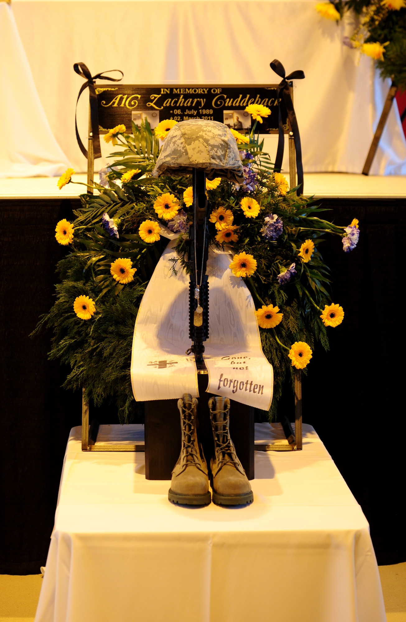 U.S. Air Force Airman 1st Class Zachery Cuddeback's battlefield cross is displayed during his memorial ceremony Ramstein Air Base, Germany, March 10, 2011. Airman Cuddeback, 86th Vehicle Readiness Squadron, was killed in action at Frankfurt International Airport March 2, 2011. (U.S. Air Force photo by Senior Airman Brittany Perry)