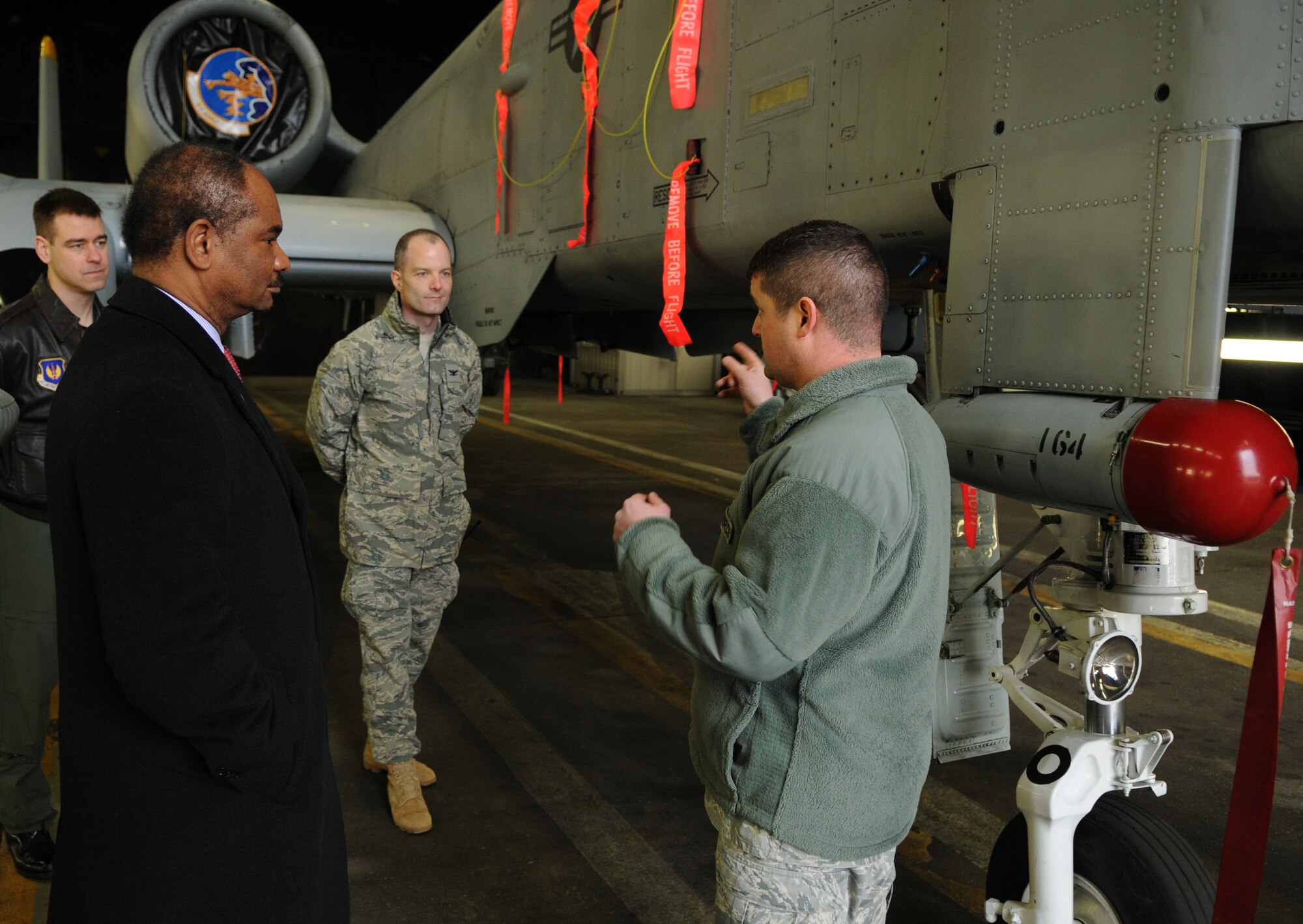 SPANGDAHLEM AIR BASE, Germany – Master Sgt. Thomas Bivens, 81st Aircraft Maintenance Unit, explains the recent upgrades to the A-10C Thunderbolt II fleet to Robert L. Gordon III, left, deputy assistant secretary of defense for military community and family policy, during Mr. Gordon’s visit here March 9. Mr. Gordon visited the 52nd Fighter Wing to better understand programs available to family members and community programs on base. (U.S. Air Force photo/Senior Airman Nathanael Callon)