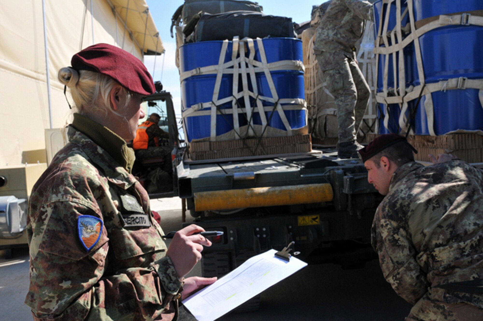 HERAT, Afghanistan  -- Italian army 1st Cpl. Maj. Ida Greco, 186th Parachute Regiment "Folgore," from Pisa, Italy, prepares to inspect pallets prior to them being loaded onto an Italian C-130J Hercules at Camp Arena, Herat Province, Afghanistan, Feb. 25, 2011. The following day, the C-130 crew airdropped cargo pallets to forward operating bases in Badghis and Farah Provinces. (U.S. Air Force photo/Tech. Sgt. Kevin Wallace)