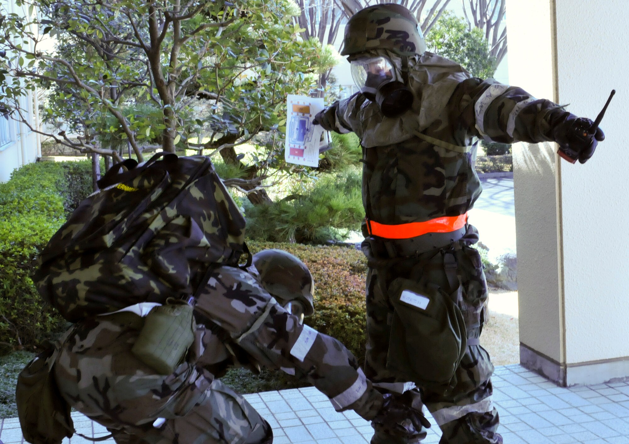 YOKOTA AIR BASE, Japan -- Post-attack reconnaissance team personnel perform a buddy check on one another to ensure that there is no contamination on them following a simulated chemical attack during an Operational Readiness Exercise here March 10. PAR teams are sent out following a suspected chemical attack to confirm whether agents are present. (U.S. Air Force photo/Airman 1st Class Krystal M. Garrett)