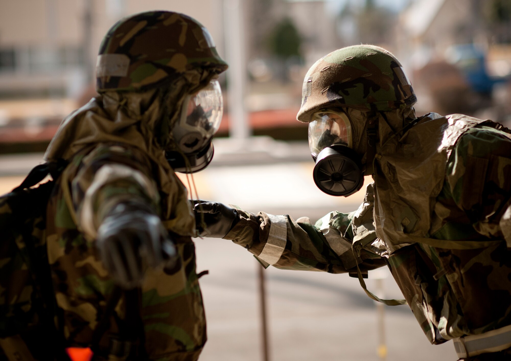 YOKOTA AIR BASE, Japan -- Tech. Sgt. Kevin Hazen and Staff Sgt. Joe Horton, 374th Comptroller Squadron post-attack reconnaissance team members, perform buddy checks before re-entering a building following a PAR sweep during an Operational Readiness Exercise here March 10. During the sweep the team is responsible for locating unexploded ordnances, personnel casualties, chemical contaminants and other hazards to report to their unit control centers. (U.S. Air Force photo/Staff Sgt. Samuel Morse)