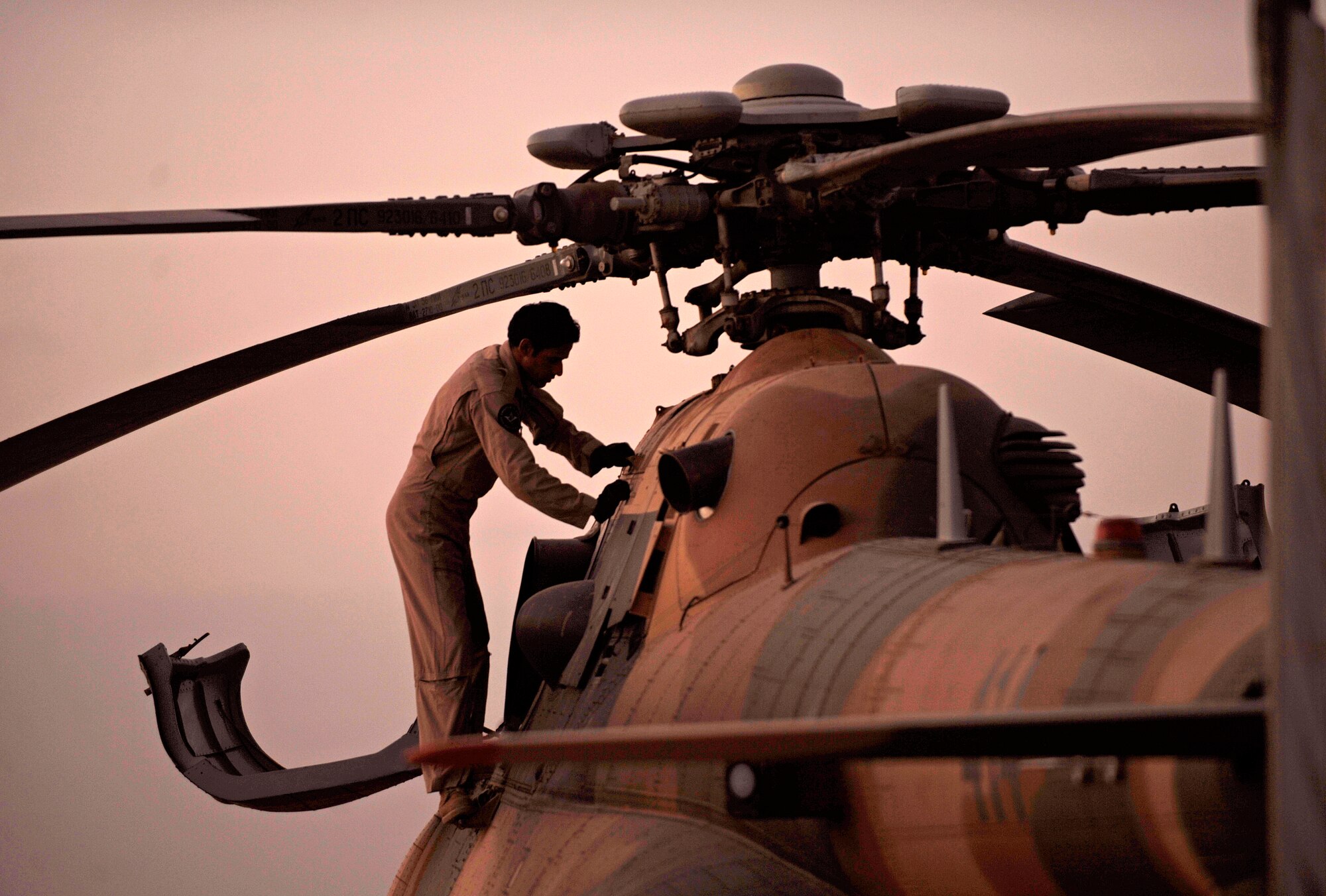 CAMP TAJI, Iraq -- An Iraqi Army Aviation Command maintainer performs pre-flight maintenance on an Mi-171 multi-mission helicopter March 1. Iraq Training and Advisory Mission - Air advises, trains and assists its Iraqi partners as they conduct various stages of helicopter pilot training and maintenance on Mi-17/171, BJR-407 and UH-1 helicopters. (U.S. Air Force/Tech. Sgt. Jason Lake)