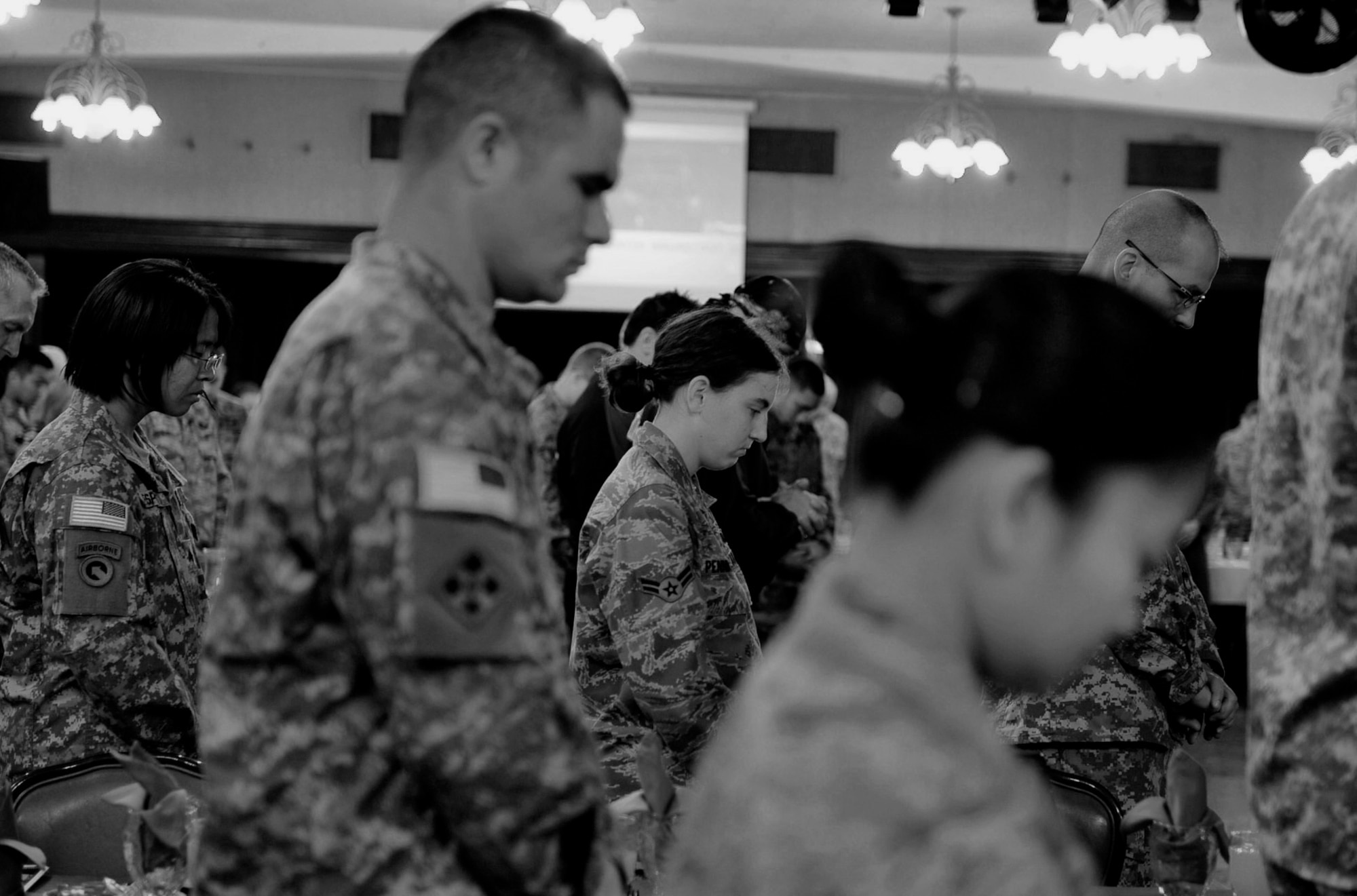 Airmen and Soldiers pray together during the 2011 National Prayer Breakfast at Kadena’s NCO Rocker Club, March 10. The National Prayer Breakfast is an annual event held by chaplains from the 18th Wing to bring people of different faiths together and pray for the nation and people around the world. This year, Team Kadena had the privilege of having members from Team Impact perform feats of strength at the breakfast. (U.S. Air Force photo/Senior Airman Sara Csurilla)