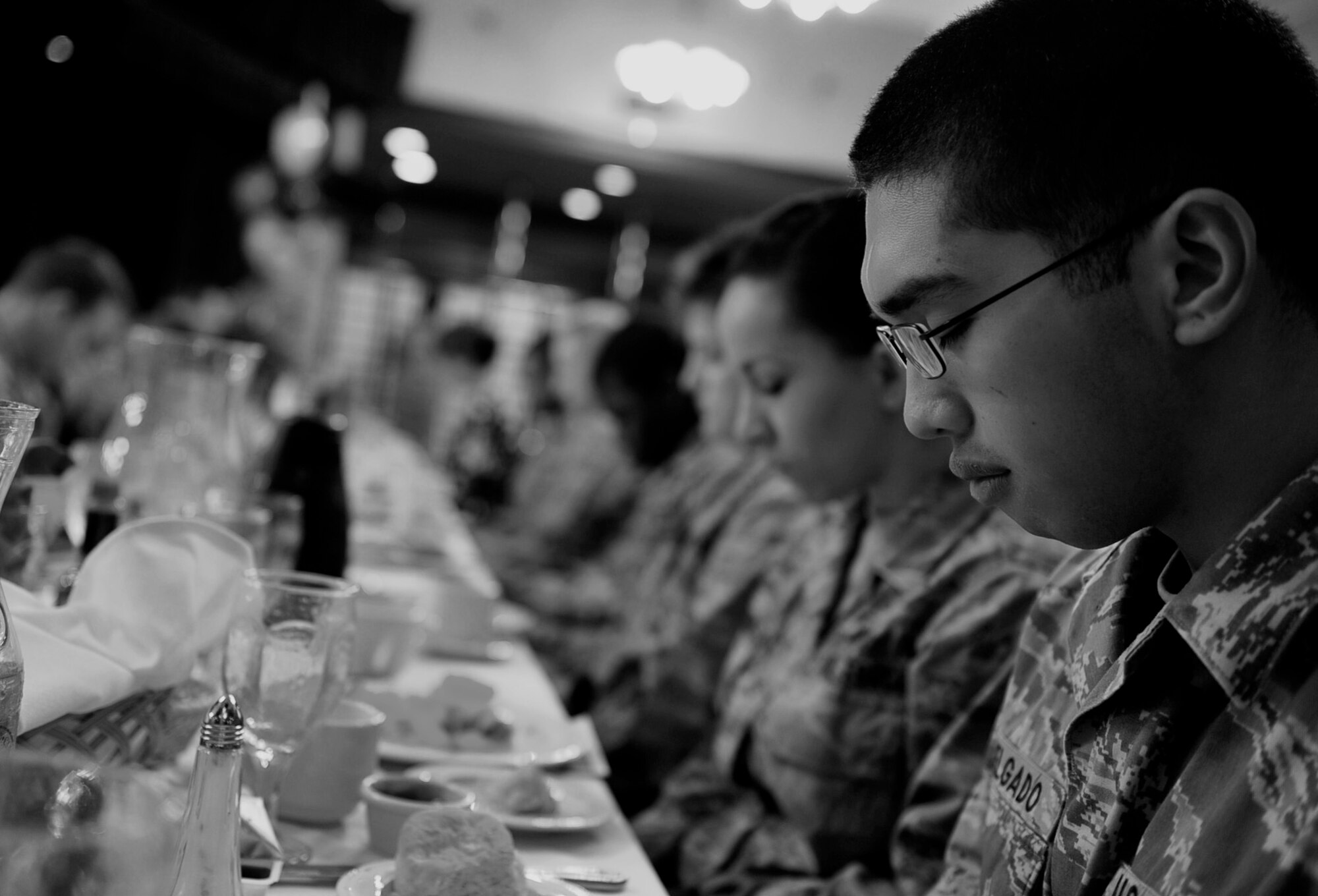 Members of Team Kadena pray together during the 2011 National Prayer Breakfast at Kadena’s Rocker NCO Club, March 10. The National Prayer Breakfast is an annual event held by chaplains from the 18th Wing to bring people of different faiths together and pray for the nation and people around the world. This year the National Prayer Breakfast had the privilege of having members of Team Impact and the Kadena Combined Choir perform. (U.S. Air Force photo/Senior Airman Sara Csurilla)