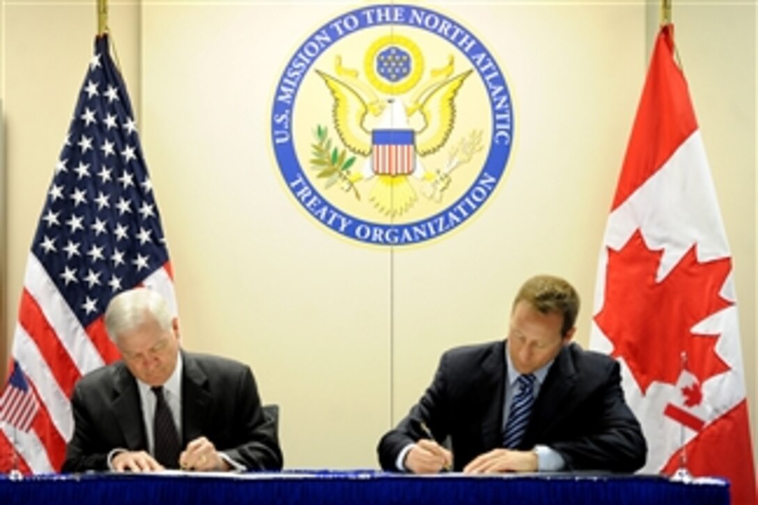 Secretary of Defense Robert M. Gates and Canadian Defense Minister Peter MacKay sign the U.S. and Canada Space Situational Awareness Partnership in NATO headquarters in Brussels, Belgium, on March 10, 2011.  Gates is in Belgium to attend NATO Defense Ministers' meetings.  