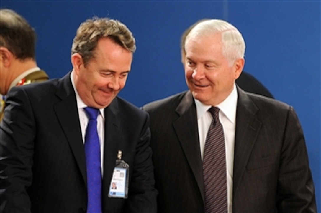 Secretary of Defense Robert M. Gates speaks with British Defense Minister Liam Fox in NATO headquarters in Brussels, Belgium, on March 10, 2011.  Gates is in Belgium to attend NATO Defense Ministers' meetings.  