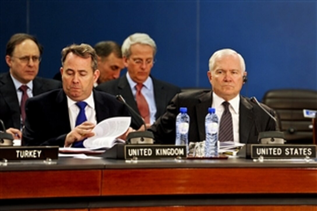 U.S. Defense Secretary Robert M. Gates, right, attends a meeting of NATO defense ministers at NATO headquarters in Brussels, Belgium, March 10, 2011.