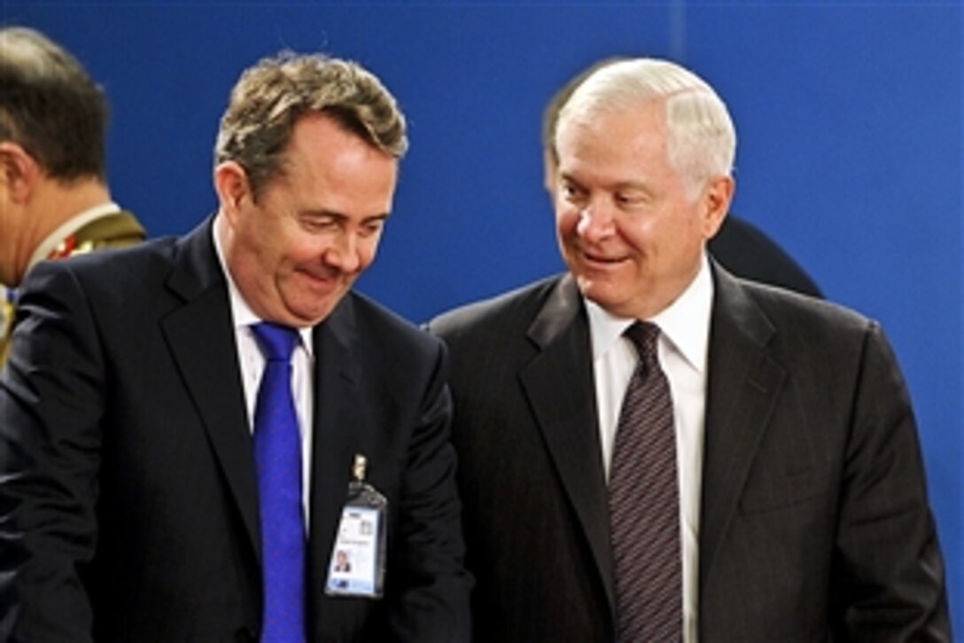 U.S. Defense Secretary Robert M. Gates, right, speaks with U.K. Defense Minister Liam Fox at NATO headquarters in Brussels, Belgium, March 10, 2011. Gates is in Belgium to attend NATO defense ministers meetings.
