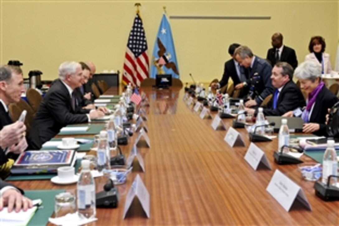 U.S. Defense Secretary Robert M. Gates, left center, meets with U.K. Defense Minister Liam Fox, opposite Gates, at NATO headquarters in Brussels, Belgium, March 10, 2011. Gates is in Belgium to attend NATO defense ministers meetings.