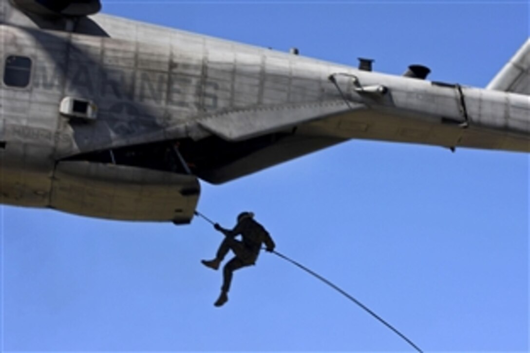 A U.S. Marine takes a leap from a CH-53E Super Stallion over Marine Corps Base Camp Pendleton, Calif., March 9, 2011. The Marine is assigned to the 1st Radio Battalion, which conducted fast-roping training.