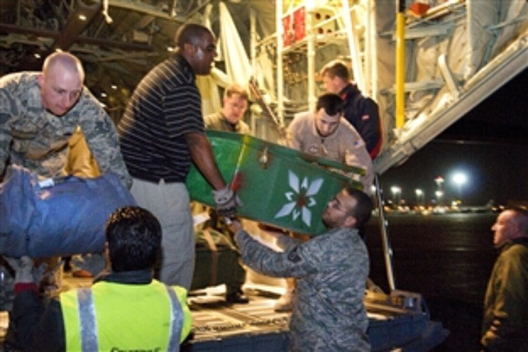 U.S. service members and Egyptian baggage handlers unload a U.S. Air Force C-130J aircraft that flew from Tunisia to Cairo, March 10, 2011. The aircraft carried Egyptian citizens who fled the conflict in Libya to Tunisia.