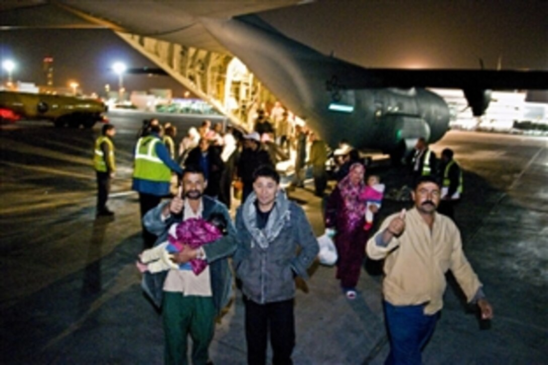 Egyptians arrive home after a long flight aboard a U.S. Air Force C-130J aircraft from Djerba Zarzis Airport in Tunisia to Cairo, March 10, 2011. Crews have been transporting Egyptians who fled the conflicts in Libya to Tunisia.
