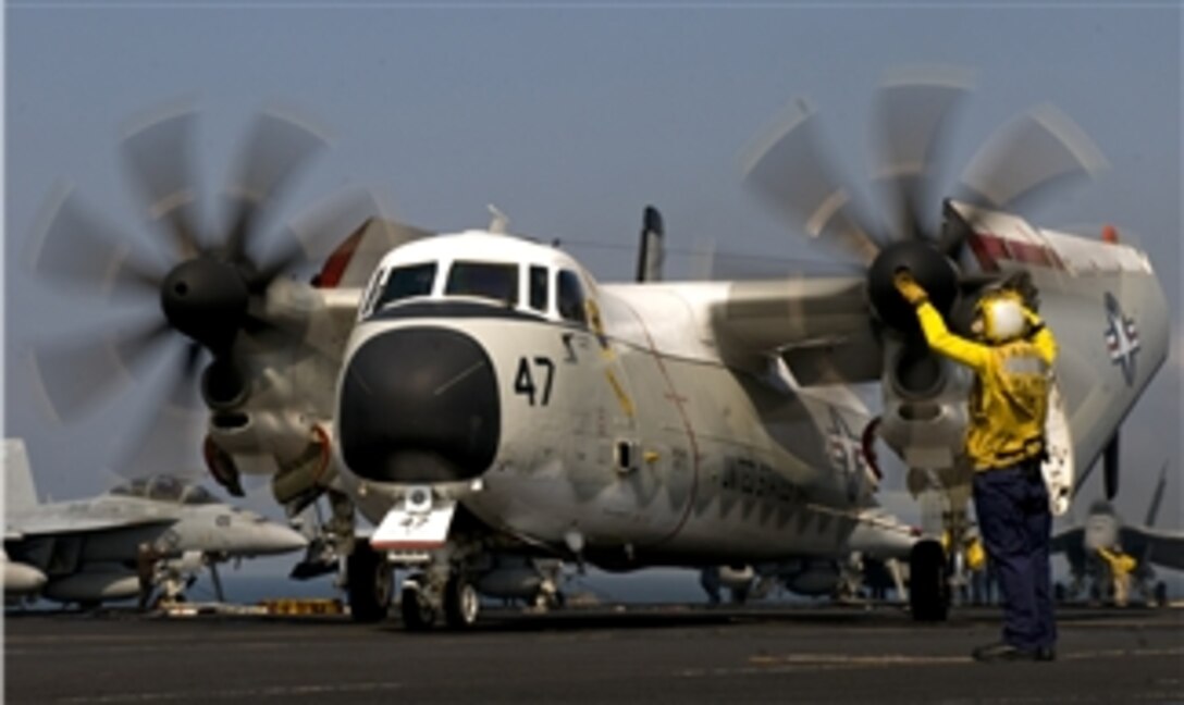 Petty Officer 2nd Class Mario Billote guides a C-2A Greyhound assigned to Fleet Logistics Support Squadron 40 aboard the aircraft carrier USS Carl Vinson (CVN 70) underway in the Arabian Sea on March 3, 2011.  The Carl Vinson Carrier Strike Group is deployed supporting maritime security operations and theater security cooperation efforts in the U.S. 5th Fleet area of responsibility.  