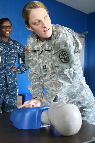 Army Capt. Kimberly Yore, station veterinary clinic officer-in-charge, performs a life-saving technique as part of the Basic Life Support Course at the Robert M. Casey Medical and Dental Clinic here March 10. The course had participants work on life-saving steps with infant and adult dolls.