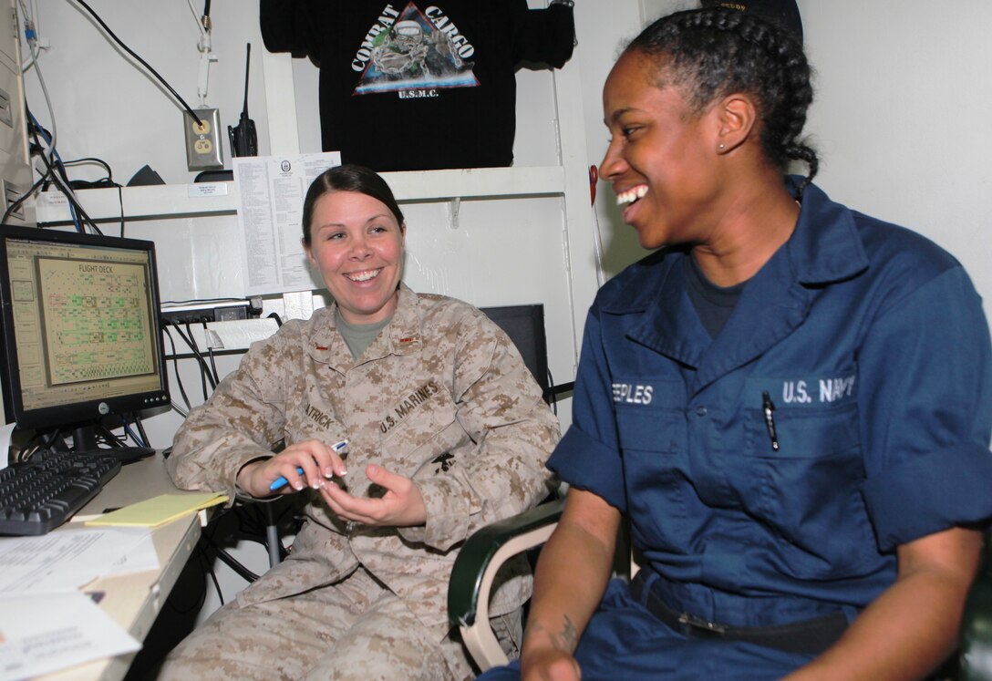 Chief Warrant Officer 2 Erin Patrick, combat cargo officer aboard the USS Harpers Ferry (LSD 49), of Mesick, Mich., talks about tax preparation with Seaman Ronika Peeples, of New Orleans, La., March 11.  As the CCO, Patrick coordinates the loading, storage, and offloading of all 31st Marine Expeditionary Unit equipment on ship.  Patrick has been deployed 18 of the last 24 months, away from her husband and four children.  She is one of the Marine Corps’ many professionals who sacrifice time with family to serve their country.  While deployed, Patrick mentors junior service members.