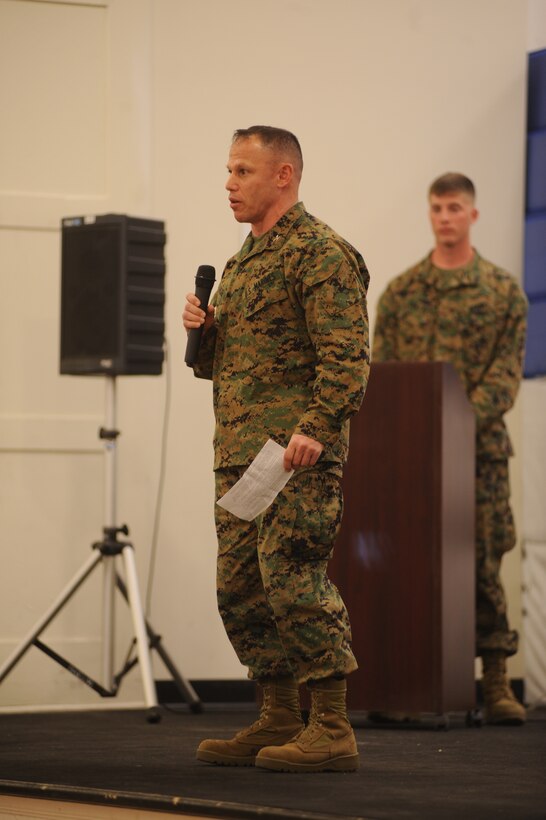 Master Gunnery Sgt. Jeron K. Chapman salutes as Lt. Col. David C. Morris passes the Marine Aerial Refueler Transport Squadron 252 colors to Lt. Col. Charles J. Moses during the VMGR-252 change of command ceremony March 11.