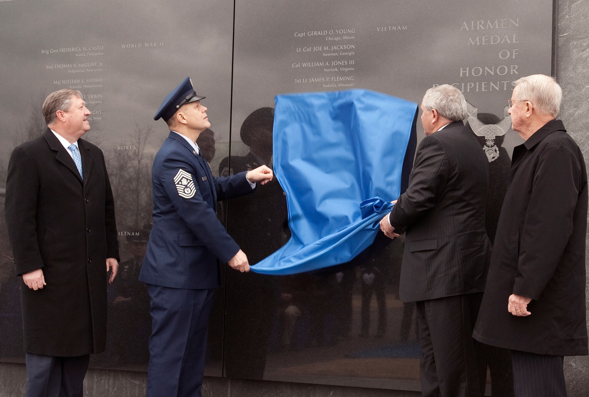 Secretary of the Air Force Michael Donley (left) and retired Chief Master Sgt. John McCauslin (right) look on March 11, 2011, as Chief Master Sgt. of the Air Force James Roy and Corey Etchberger unveil Medal of Honor recipient Chief Master Sgt. Richard L. Etchberger's name March 11, 2011, which was added to the Air Force Memorial in Arlington, Va.  (U.S. Air Force photo/Jim Varhegyi)