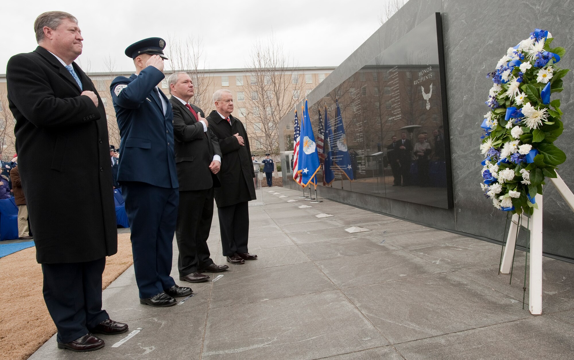 Secretary of the Air Force Michael Donley (from left), Chief Master Sgt. of the Air Force James Roy, Corey Etchberger, and retired Chief Master Sgt. John McCauslin pay their respects as Taps is played during a ceremony March 11, 2011, to unveil Medal of Honor recipient Chief Master Sgt. Richard L. Etchberger's name which was added to the Air Force Memorial in Arlington, Va.  (U.S. Air Force photo/Jim Varhegyi)