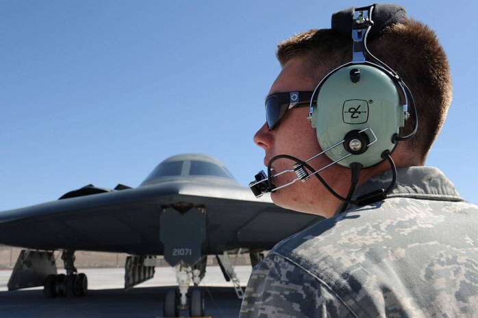 NELLIS AIR FORCE BASE, Nev., --  Senior Airman Mark Dixon, 509th Aircraft Maintenance Squadron crew chief, from Whiteman Air Force Base, Mo., communicates through his headset with a B-2 Spirit pilot during Red Flag 11-3 at Nellis Air Force Base, March 8. Red Flag is a realistic combat training exercise for the United States  and its allies. During Red Flag,  military units are able to test their skill and firepower over the Nevada Test and Training Range. (U.S. Air Force photo by Staff Sgt. Taylor Worley)