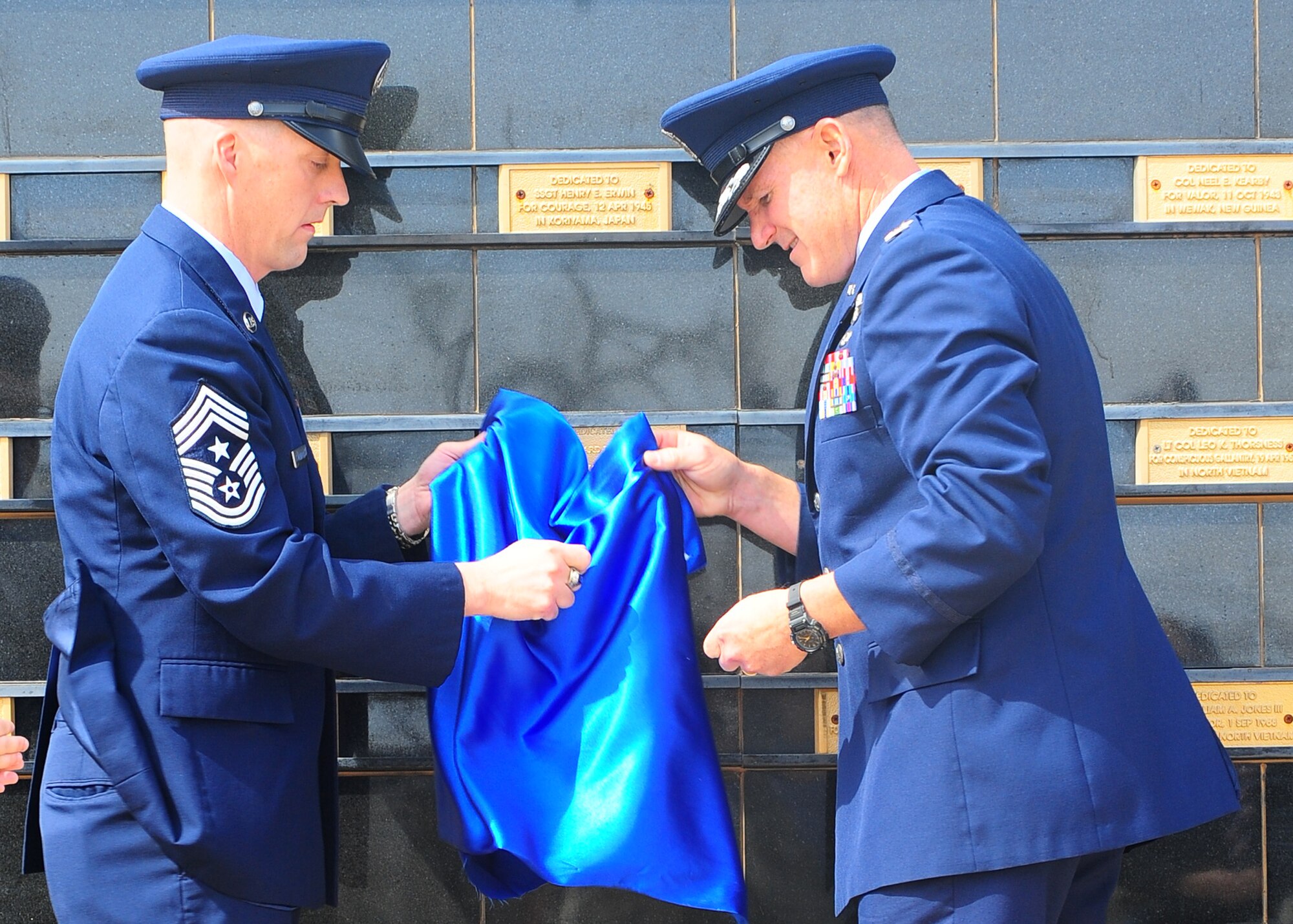DYESS AIR FORCE BASE, Texas – Chief Master Sgt. Douglas McIntyre, 7th Bomb Wing command chief, and Col. Brian Donahoo, 7th Bomb Wing vice commander, unveil a plaque March 11 honoring Chief Master Sgt. Richard Loy Etchberg, during a Medal of Honor ceremony held at the Dyess Medal of Honor Memorial here. Chief Etchberg was a Senior NCO in the U.S. Air Force who posthumously received the military’s highest decoration, the Medal of Honor, for his actions during the Battle of Lima Site 85 in the Vietnam War. The medal was formally presented to his three sons by President Barack Obama during a ceremony at the White House on Sept. 21, 2010. (U.S. Air Force photo/ Airman 1st Class Courtney Moses)