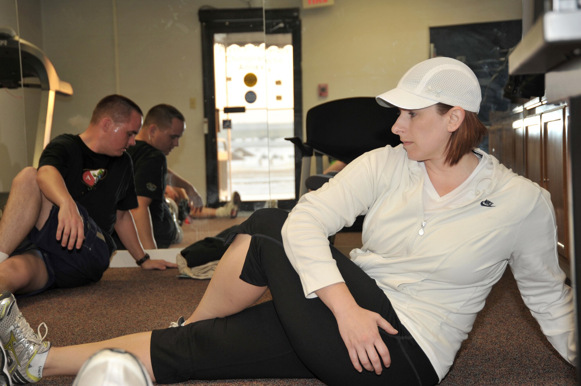 Marcy Jameson leads participants in the Get Fit Run class at Offutt Air Force Base, Neb., in some post-running stretching. Ms. Jameson is an exercise physiologist and the health and wellness center flight chief at Offutt AFB. (U.S. Air Force photo/D.P. Heard) 