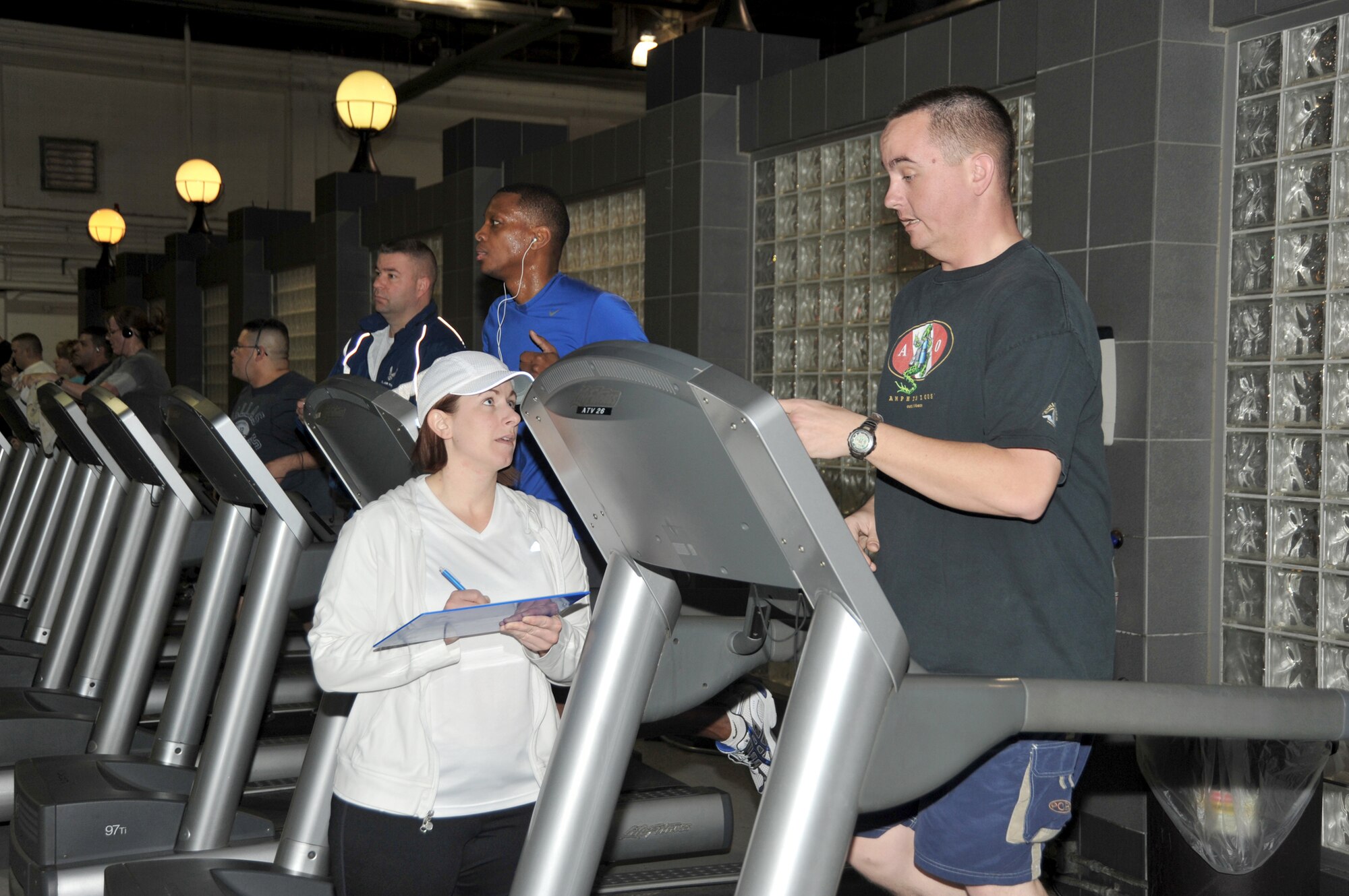 Marcy Jameson talks with Senior Airman Justin Speck during the Get Fit Run class at Offutt Air Force Base, Neb. Ms. Jameson is an exercise physiologist and the health and wellness center flight chief at Offutt AFB. Airman Speck is a member of the 55th Logistics Readiness Squadron. (U.S. Air Force photo/D.P. Heard)